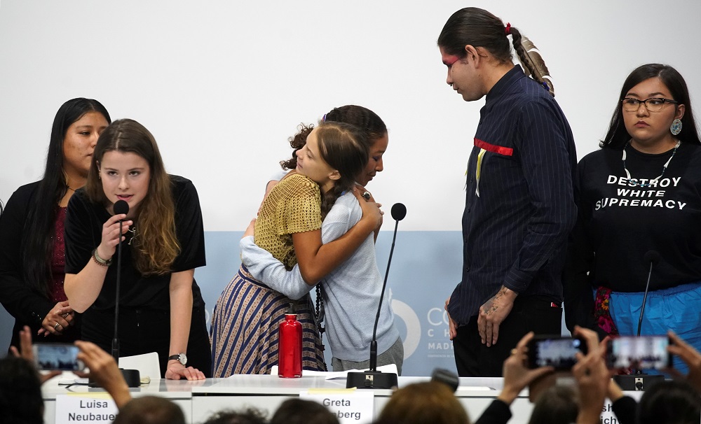 Climate change activist Greta Thunberg embraces a girl as she attends a news conference during COP25 climate summit in Madrid December 9, 2019. u00e2u20acu201d Reuters pic