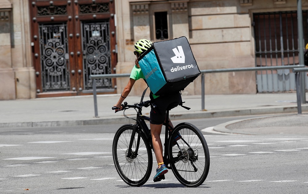 A biker wearing a Deliveroo backpack drives in the central Barcelona July 23, 2019. u00e2u20acu201d Reuters pic