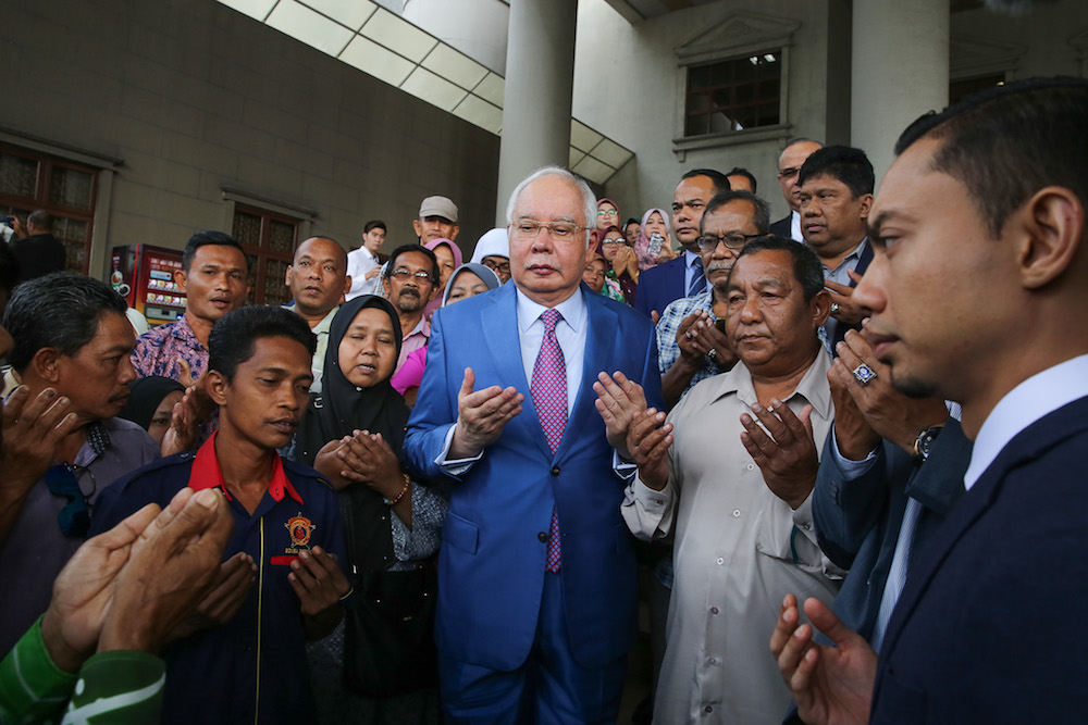 Former prime minister Datuk Seri Najib Razak prays with supporters at the Kuala Lumpur Courts Complex December 3, 2019. u00e2u20acu201d Picture by Yusof Mat Isa