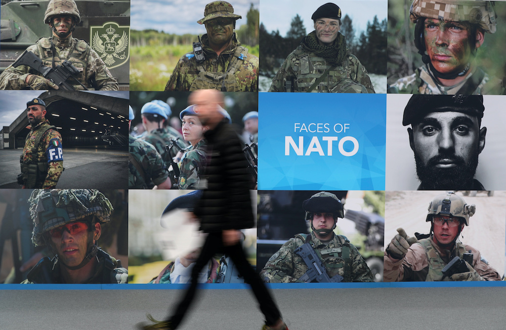 A man walks past a NATO sign ahead of a NATO leaders summit at the Grove in Watford, Britain December 3, 2019. u00e2u20acu201d Reuters pic
