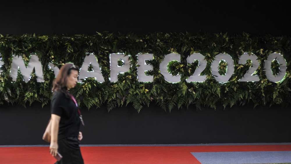 A woman walks past the Asia-Pacific Economic Cooperation (Apec) logo in Cyberjaya December 4, 2019. u00e2u20acu201d Picture by Shafwan Zaidon