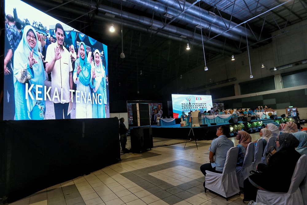 Delegates watch a video presentation during the PKR Women and Youth National Congress in Melaka December 4,2019. — Picture by Ahmad Zamzahuri