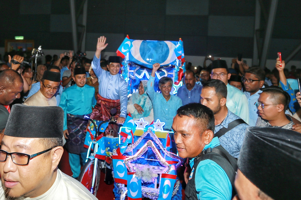 PKR deputy president Datuk Seri Azmin Ali makes his entrance cycling a trishaw with PKR vice presidents Zuraida Kamaruddin and Chua Tian Chang seated in the passenger seat December 5, 2019. — Picture by Yusof Mat Isa