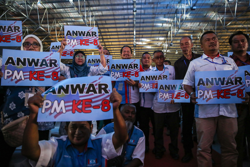 Delegates hold up placards during the 2019 PKR National Congress at MITC in Ayer Keroh, Melaka December 8, 2019. — Picture by Yusof Mat Isa