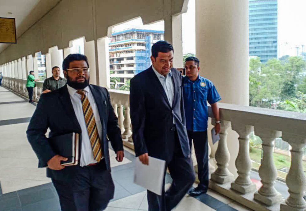 Former MCMC deputy director Mohd Iskandar King (centre) is pictured at the Kuala Lumpur High Court December 19, 2019.