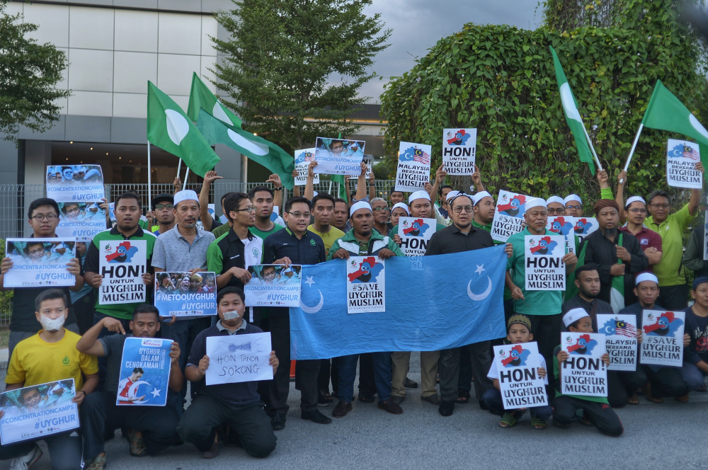 Protesters hold placards and march as they attend a u00e2u20acu02dcsilent protestu00e2u20acu2122 by Angkatan Belia Islam Malaysia (Abim) and Global Peace Mission (GPM) Malaysia at BACC in Kajang December 21, 2019. u00e2u20acu201d Picture by Shafwan Zaidon