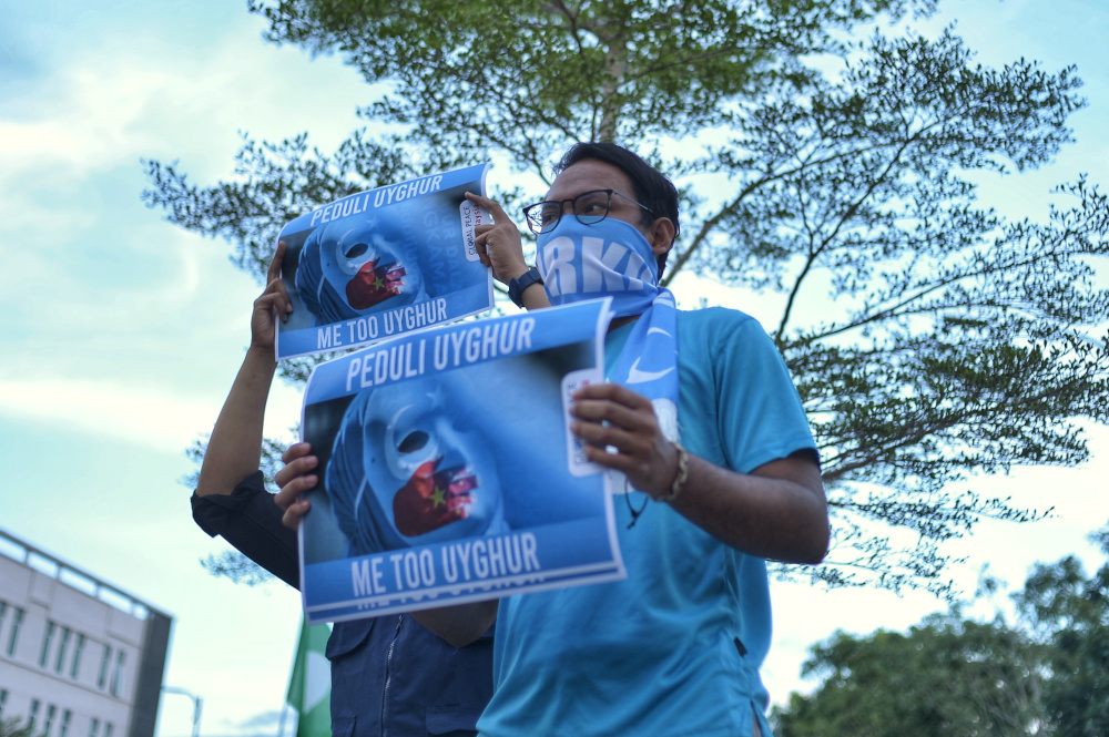Protesters hold placards and march as they attend a ‘silent protest’ by Angkatan Belia Islam Malaysia (Abim) and Global Peace Mission (GPM) Malaysia at BACC in Kajang December 21, 2019. — Picture by Shafwan Zaidon