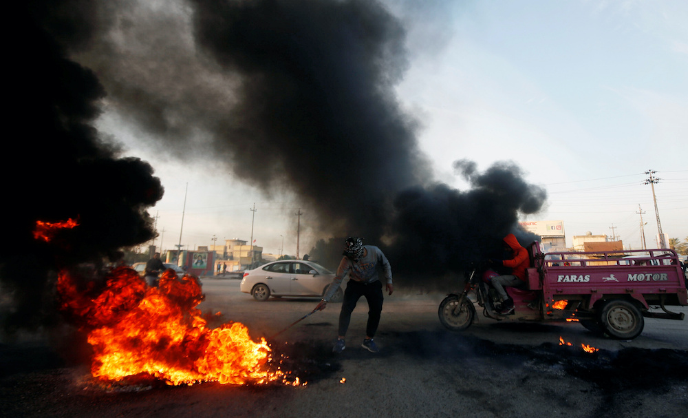An Iraqi protester burns tires during ongoing anti-government protests in Basra, Iraq December 22, 2019. u00e2u20acu201d Reuters pic