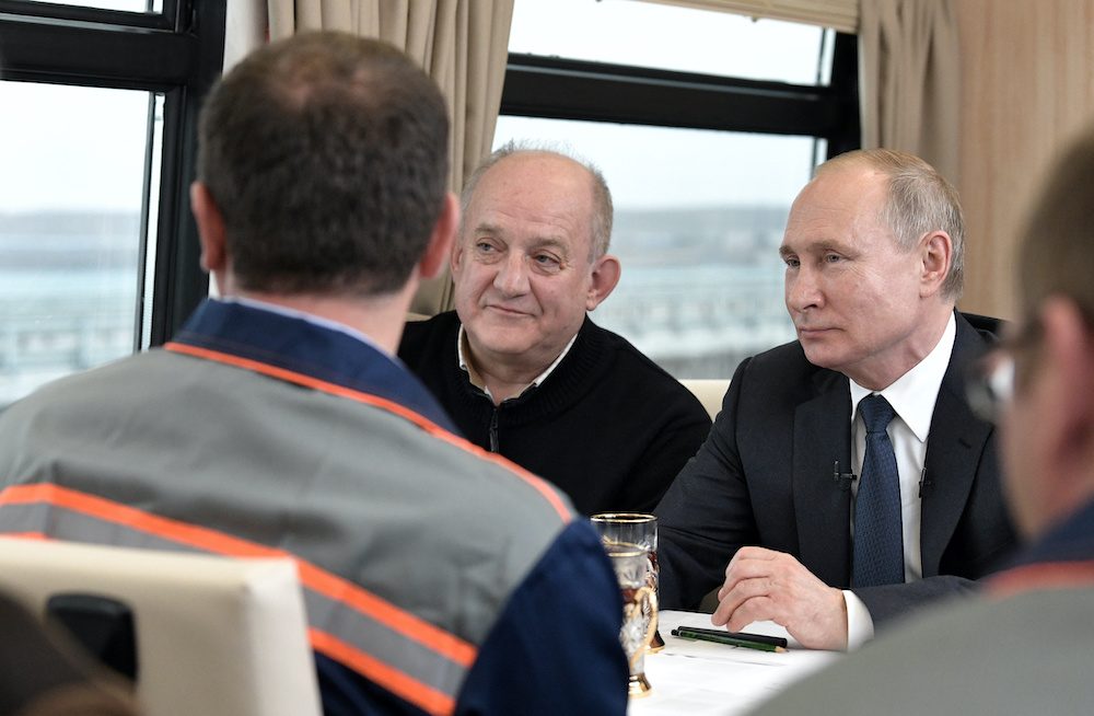 Russian President Vladimir Putin listens to construction workers as he travels by train from Kerch to Taman across a bridge December 23, 2019. u00e2u20acu201d Reu