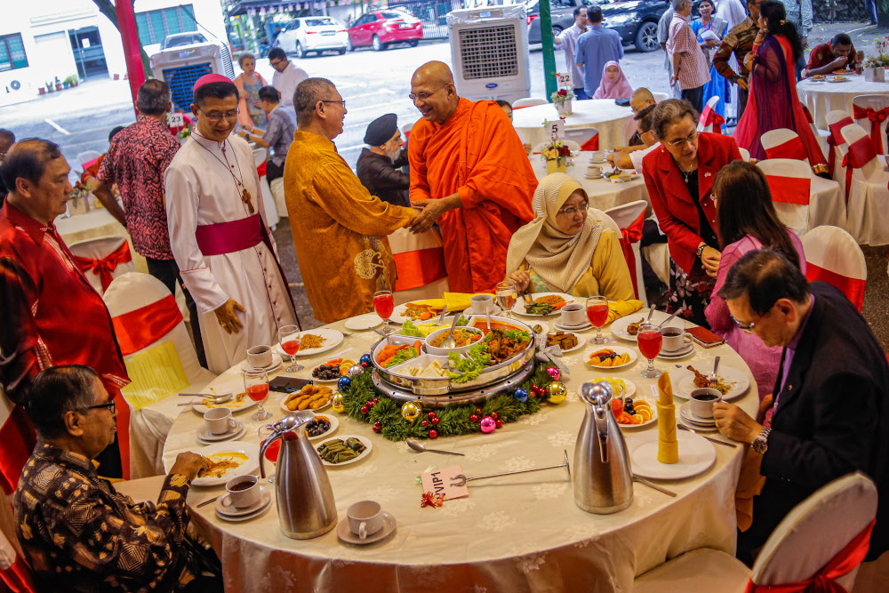 Foreign Minister Datuk Saifuddin Abdullah together with Archbishop of Kuala Lumpur Julian Leow mingle with guests at the CFM Christmas High-Tea in Kuala Lumpur December 25, 2019. — Picture by Hari Anggara