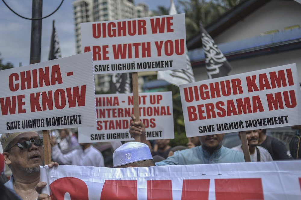 Protesters march while holding placards during a protest held in solidarity with the Uighur community in China, in Kuala Lumpur December 27, 2019. — Picture by Shafwan Zaidon