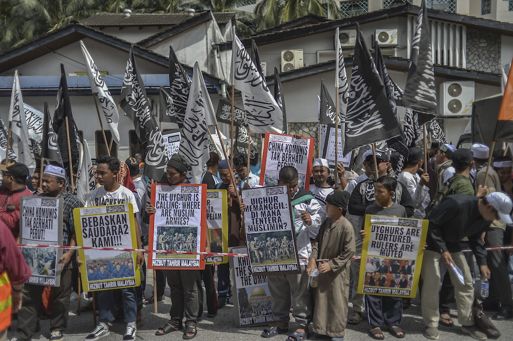 Protesters march while holding placards during a protest held in solidarity with the Uighur community in China, in Kuala Lumpur December 27, 2019. — Picture by Shafwan Zaidon
