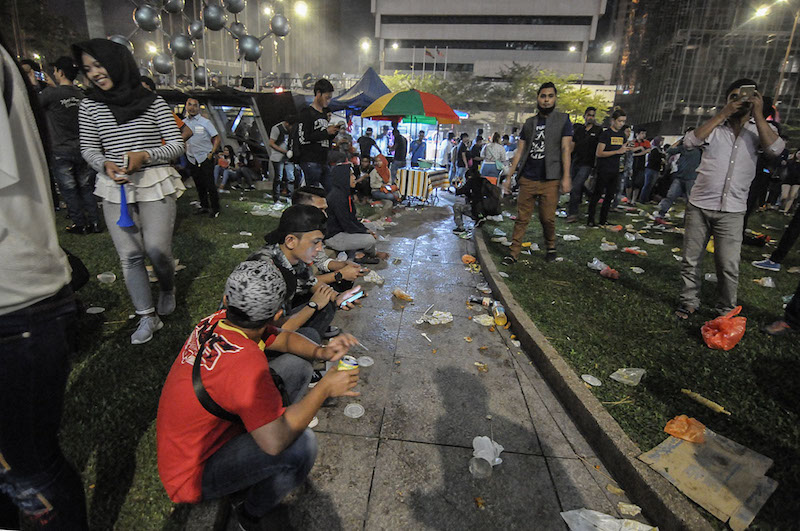 Seen here are those celebrating New Year’s Day in KLCC, with rubbish strewn all over the ground. January 1, 2018 — Picture by Miera Zulyana