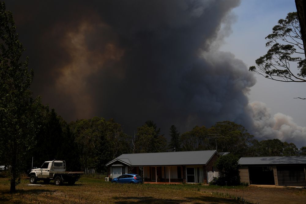 A home is seen as smoke from the Grose Valley Fire rises in the distance, at Bilpin, New South Wales, Australia, December 21, 2019. u00e2u20acu201d AAP Image/Dan Himbrechts via Reuters