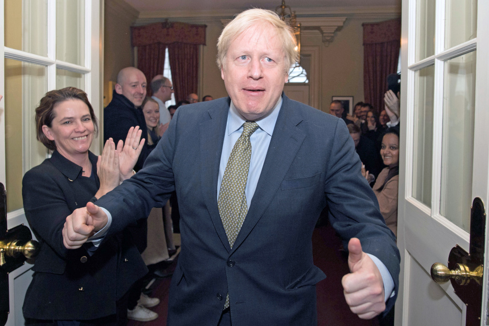 Britainu00e2u20acu2122s Prime Minister Boris Johnson reacts as he is greeted by staff, arriving back at Downing Street, after meeting Queen Elizabeth and accepting her invitation to form a new government, in London, Britain December 13, 2019. u00e2u20acu201d Reuters pic 