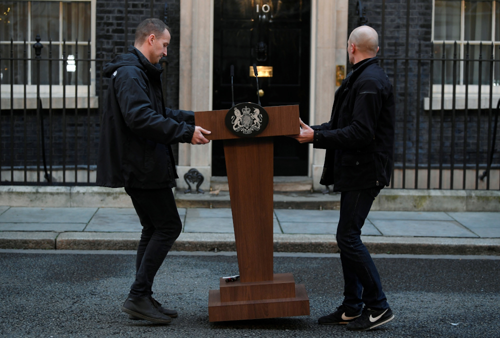 Workers carry a podium ahead of Britainu00e2u20acu2122s Prime Minister Boris Johnson statement at Downing Street after winning the general election, in London, Britain, December 13, 2019. u00e2u20acu201d Reuters pic 