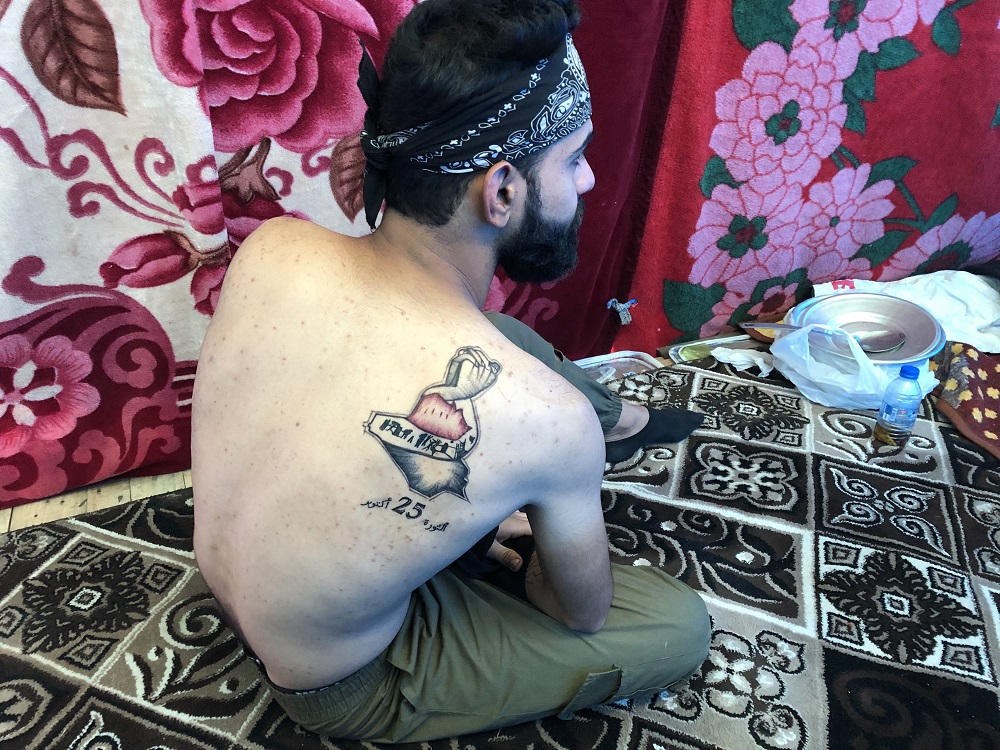 An Iraqi man displays his tattoo in the capital Baghdad on December 9, 2019. u00e2u20acu201d AFP pic