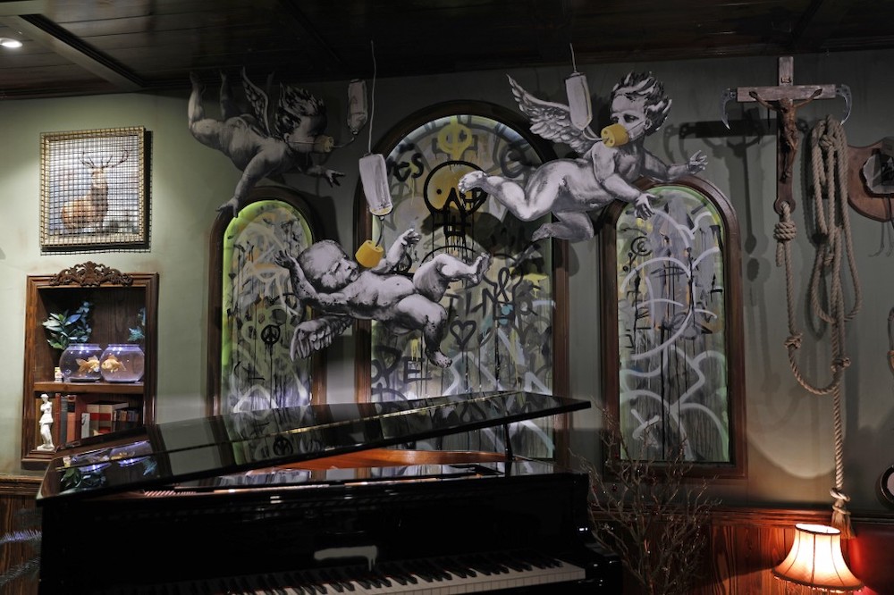 Illustrations by street artist Banksy are displayed in his Walled-Off hotel in the Israeli occupied West Bank town of Bethlehem on December 20, 2019. u00e2u20acu2022 AFP picnn