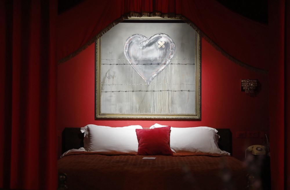 Illustrations by street artist Banksy are displayed in his Walled-Off hotel in the Israeli occupied West Bank town of Bethlehem on December 20, 2019. ― AFP pic