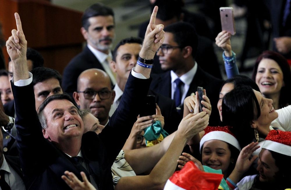 Brazilu00e2u20acu2122s President Jair Bolsonaro gestures while attending a Christmas event, at the Federal District public school in Brasilia on December 19, 2019. u00e2u20acu201d AFP pic