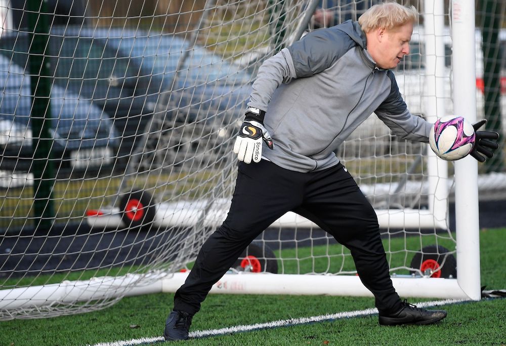 Britainu00e2u20acu2122s Prime Minister Boris Johnson tries to save a goal during a warm up before the Hazel Grove United JFC vs Poynton Juniors girls soccer match, as he campaigns in Cheadle Hulme, Britain December 7, 2019. u00e2u20acu201d Reuters picnnn