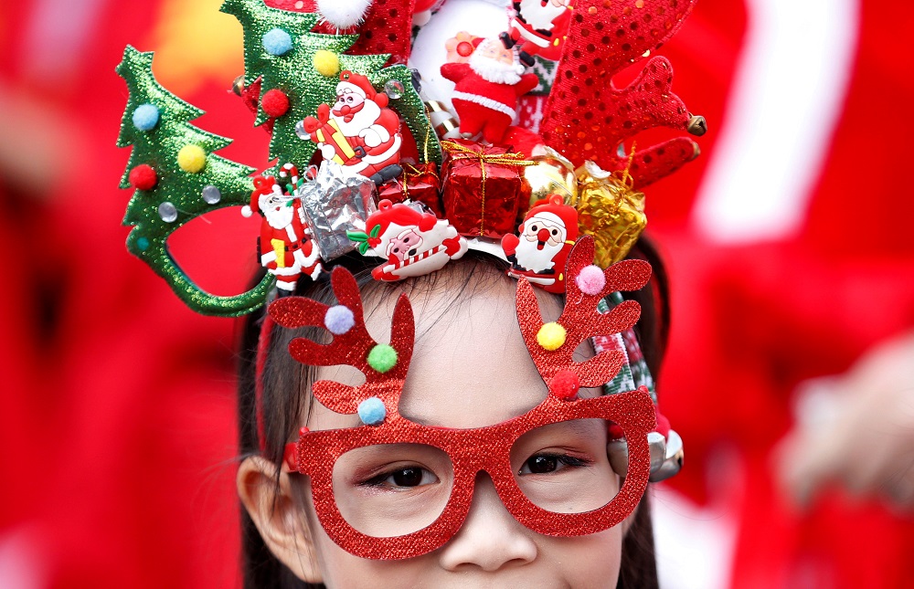 A student waits as she takse part in a visit with a troupe of elephants (unseen) to distribute Christmas presents to students in a school at the historical city of Ayutthaya, Thailand December 23, 2019. u00e2u20acu201d Reuters pic