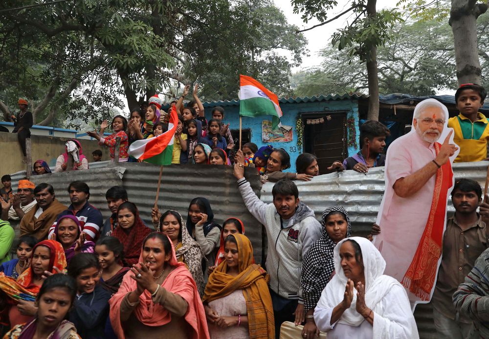 People, who claim to have migrated from Pakistanu00e2u20acu2122s Sindh Province, cheer next to a cutout of Indiau00e2u20acu2122s Prime Minister Narendra Modi as they celebrate after Indiau00e2u20acu2122s parliament passed a Citizenship Amendment Bill (CAB), at Majnu Ka Tila in New Delhi, In