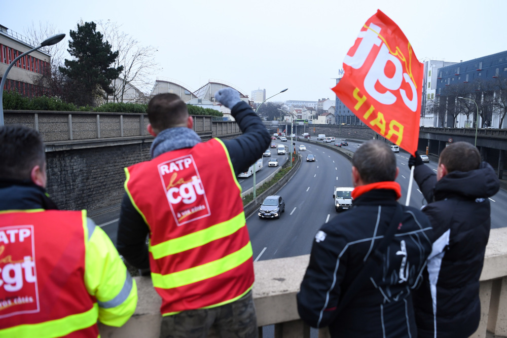 Paris public transports operator RATP employees wave a flag bearing the logo of the French trade union General Confederation of Labour near place du00e2u20acu2122Italie during a strike of the RATP employees in Paris, December 5, 2019. u00e2u20acu201d AFP pic 