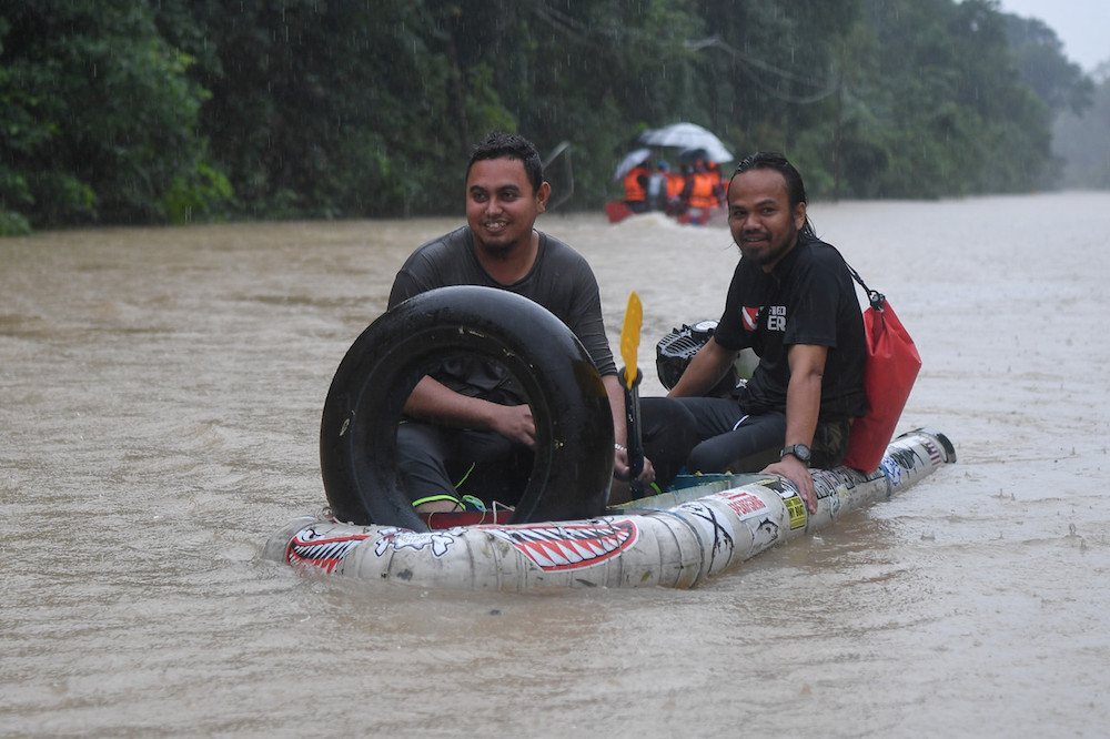 Men travel in a homemade boat made of PVC pipes and plastic drums in Kampung Bekok, Besut December 3, 2019. u00e2u20acu201d Bernama pic
