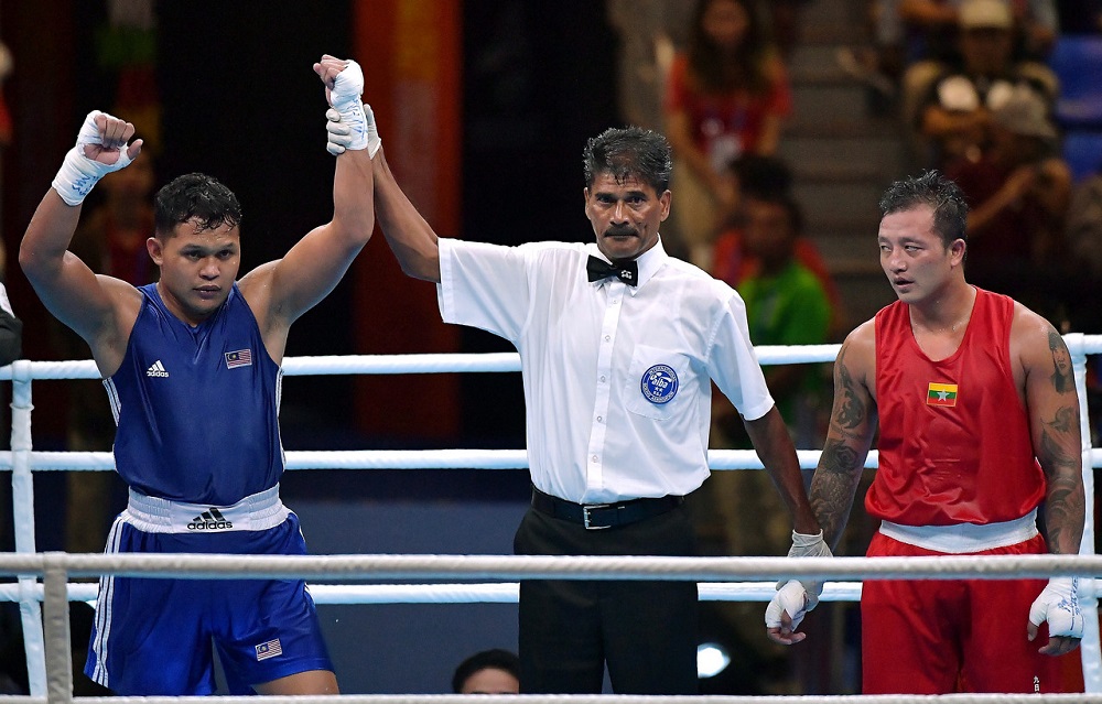 Malaysian boxer Khir Akyazlan Azmi (left) after winning the match against Tun Ye Lin of Myanmar at the SEA Games in Manila December 5, 2019. u00e2u20acu201d Bernama pic