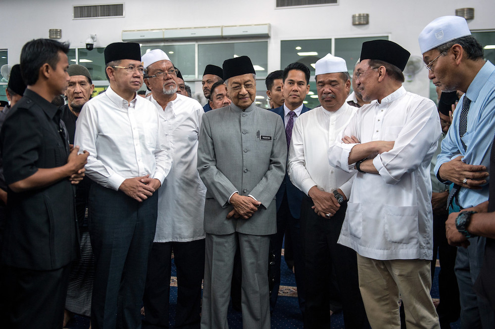 Tun Dr Mahathir Mohamad and other Cabinet ministers speak to Datuk Seri Anwar Ibrahim during the funeral of his father-in-law Datuk Wan Ismail Wan Mahmood at Al Mustaqim Mosque in Ampang December 10, 2019. — Bernama pic