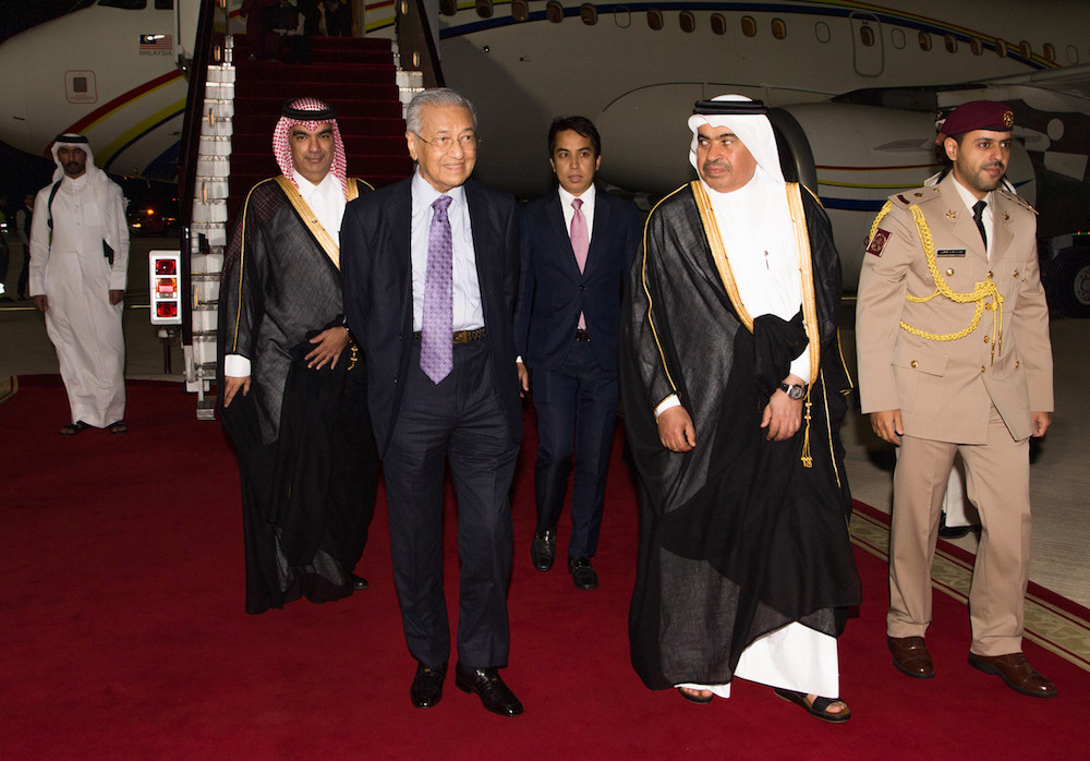 Prime Minister Tun Dr Mahathir Mohamad is greeted by Qataru00e2u20acu2122s Minister of Commerce and Industry, Ali bin Ahmed Al Kuwari upon arrival at the Hamad International Airport December 12, 2019. u00e2u20acu201d Bernama pic