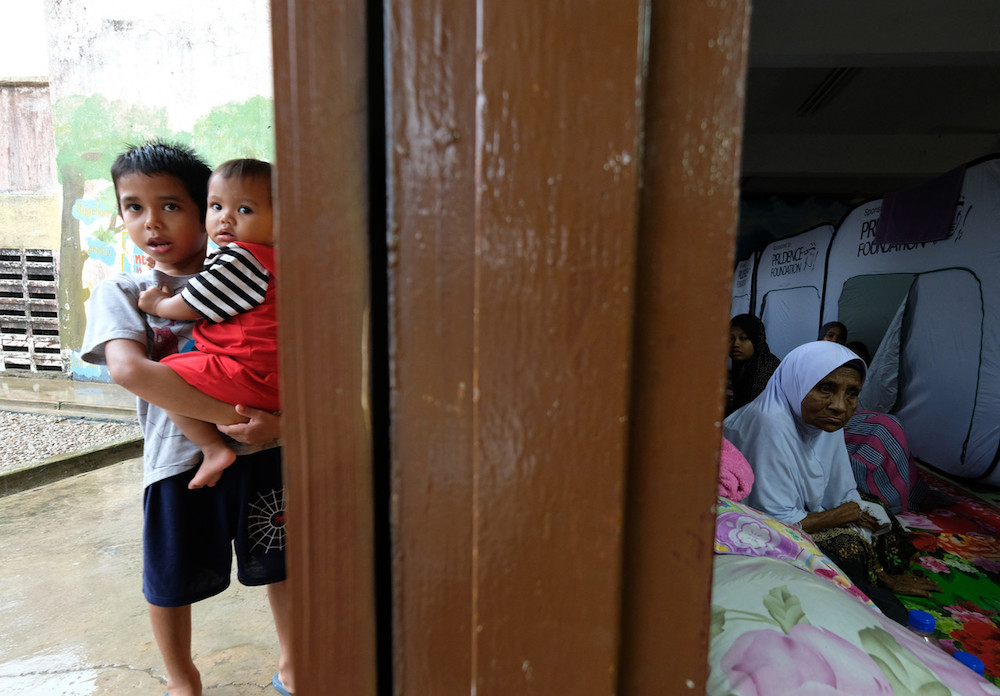 A family seeks shelter at an evacuation centre in Sekolah Kebangsaan Kampung Pianggu in Rompin December 15, 2019. u00e2u20acu201d Bernama pic