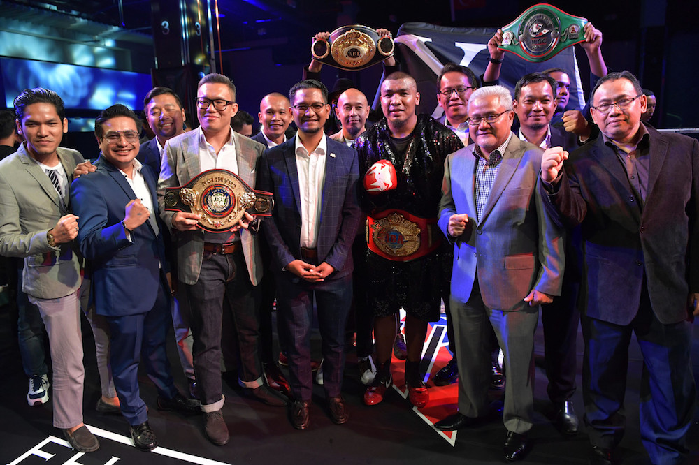 National professional boxer Muhammad Farkhan Haron poses with his belts after successfully defending his titles at the Johor International Boxing Championships 2019 in Johor Baru December 29, 2019. u00e2u20acu201d Bernama pic