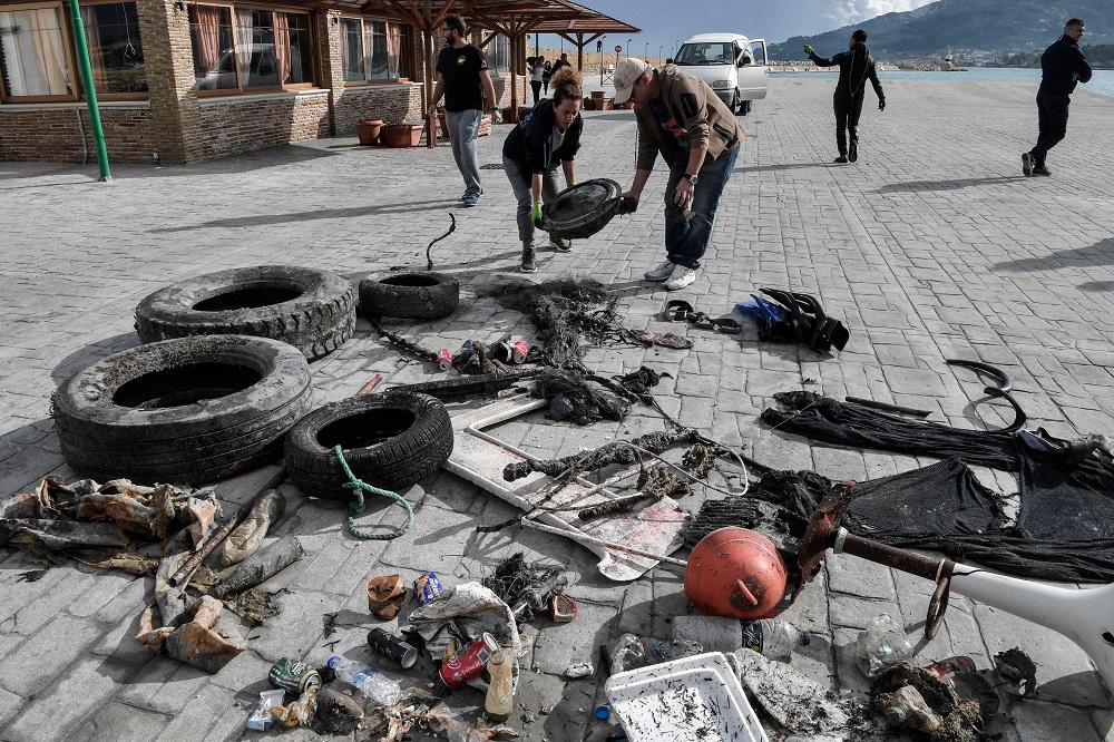 Volunteers from Aegean Rebreath, a Greek organisation formed in 2017 to protect Aegean biodiversity from waste, collect rubbish retrieved from the sea, at the port of the island of Zakynthos November 23, 2019. — AFP pic