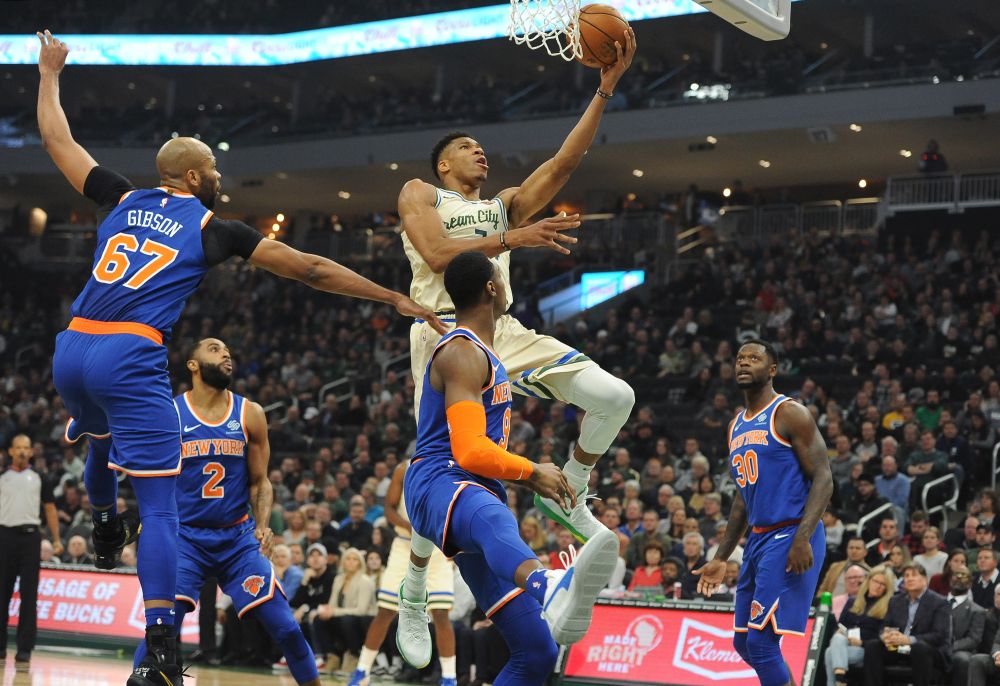 Milwaukee Bucks forward Giannis Antetokounmpo (34) lays up a shot against New York Knicks forward RJ Barrett (9) and forward Julius Randle (30) in the first quarter at Fiserv Forum. u00e2u20acu201d Reuters pic