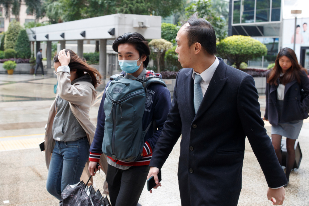 Tsang Chi-Kin (centre), who was shot by a police officer during a protest, arrives for a court hearing in Hong Kong, China, December 5, 2019. u00e2u20acu201d AFP pic  
