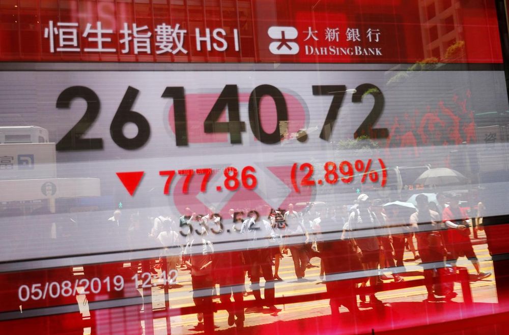The reflections of pedestrians are seen on a screen displaying the Hang Seng stock index in Hong Kong, China August 5, 2019. u00e2u20acu201d Reuters pic