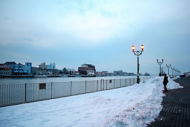 Thick walls of snow guard each bank of Kushiro River