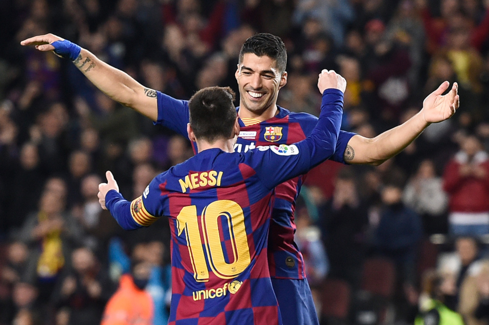 Barcelona forward Lionel Messi celebrates his third goal with forward Luis Suarez during the Spanish League football match between FC Barcelona and RCD Mallorca at the Camp Nou stadium in Barcelona December 7, 2019. u00e2u20acu201d AFP pic