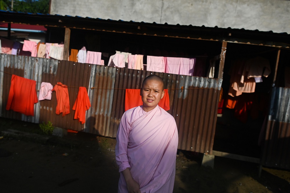This photo taken on October 19, 2019 shows Buddhist nun Dhama Theingi posing for a photo at the Mingalar Thaikti nunnery in Yangon. u00e2u20acu201d AFP pic    