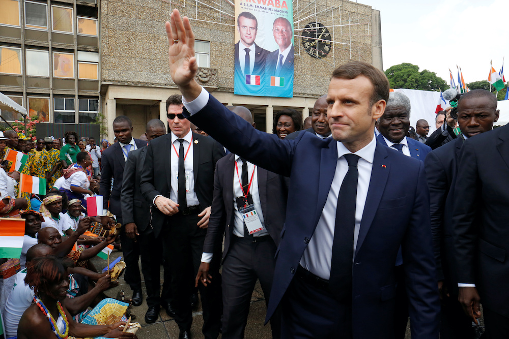 Franceu00e2u20acu2122s President Emmanuel Macron greets people after arriving to meet with Robert Beugre Mambe, Governor of the Abidjan district, at the town hall in Abidjan, Ivory Coast December 21, 2019. u00e2u20acu2022 Reuters picnn