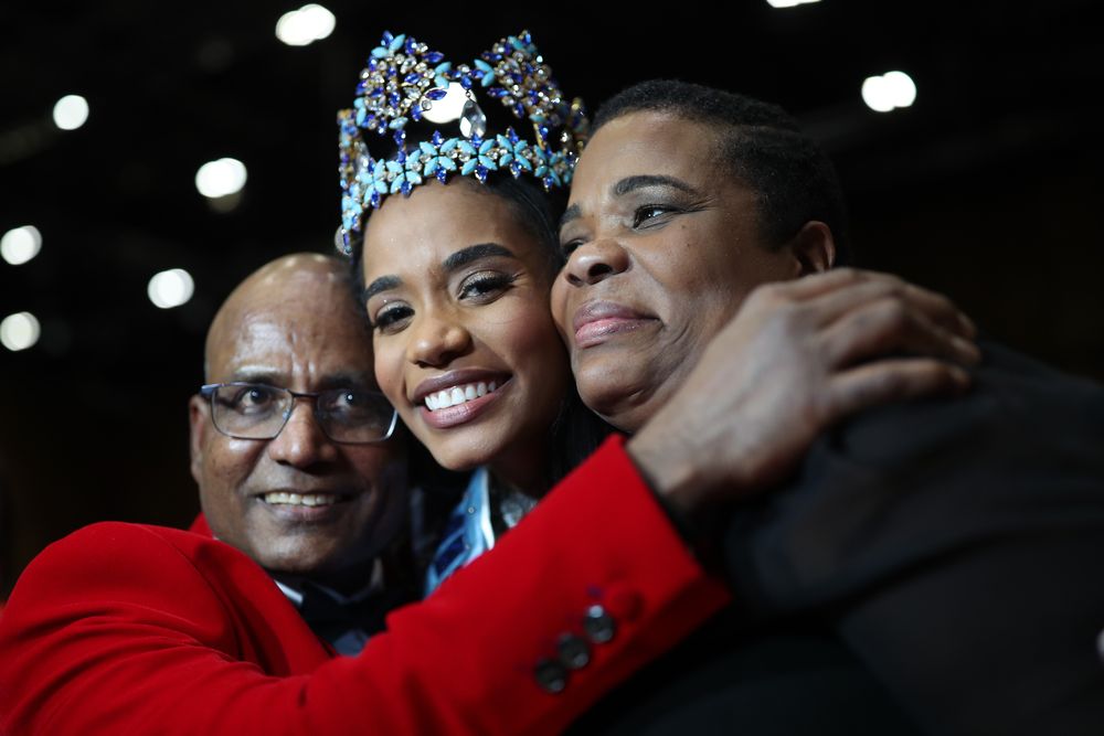Miss Jamaica 2019, Toni-Ann (centre), embraces her parents Bradshaw Singh and Jahrine Bailey after she is announced Miss World 2019, during the 69th Miss World annual final at the ExCel London. u00e2u20acu201d Reuters pic