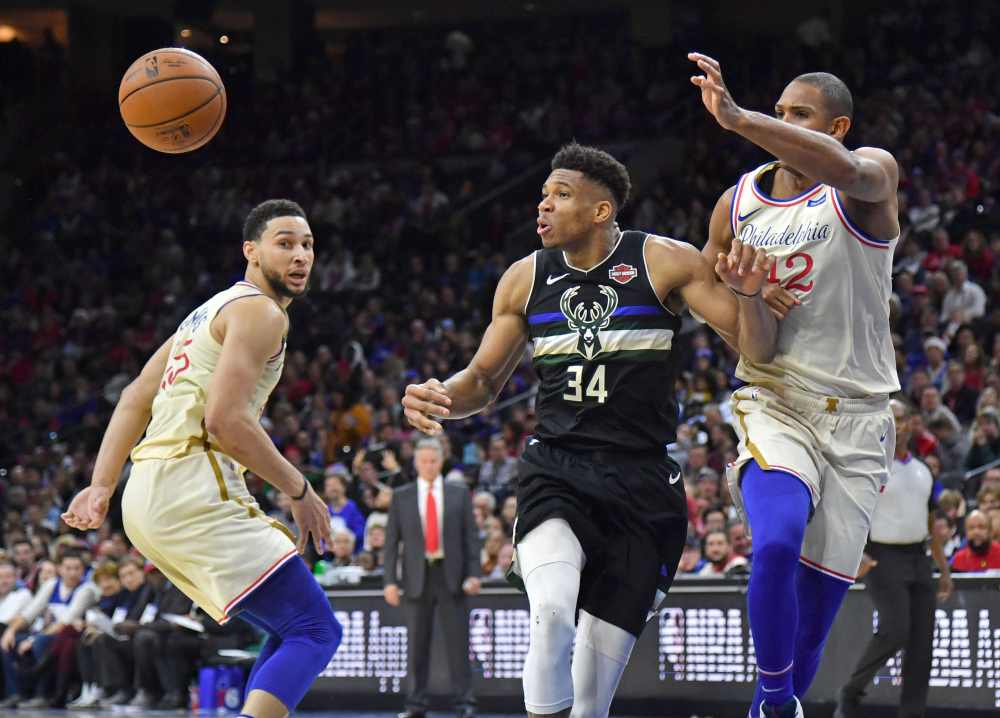 Milwaukee Bucks forward Giannis Antetokounmpo (34) loses control of the ball giants Philadelphia 76ers center Al Horford (42) and guard Ben Simmons (25) during the fourth quarter at Wells Fargo Center. u00e2u20acu2022 Eric Hartline-USA TODAY Sports pic via Reuters