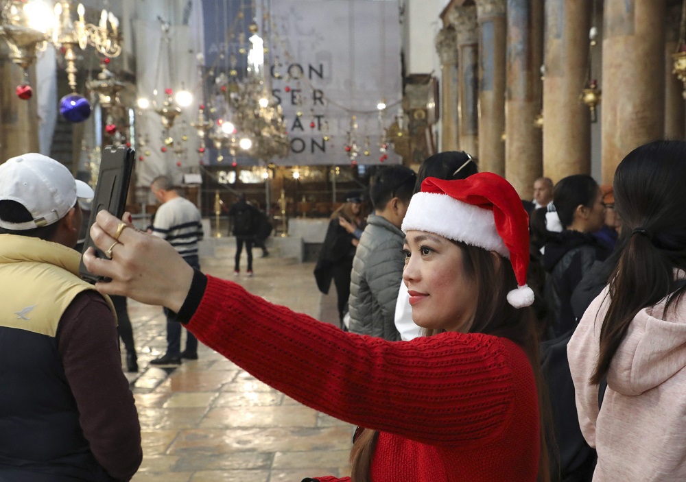 A pilgrim takes a selfie at the Church of the Nativity in the city of Bethlehem in the occupied West Bank December 22, 2019. u00e2u20acu201d AFP pic 