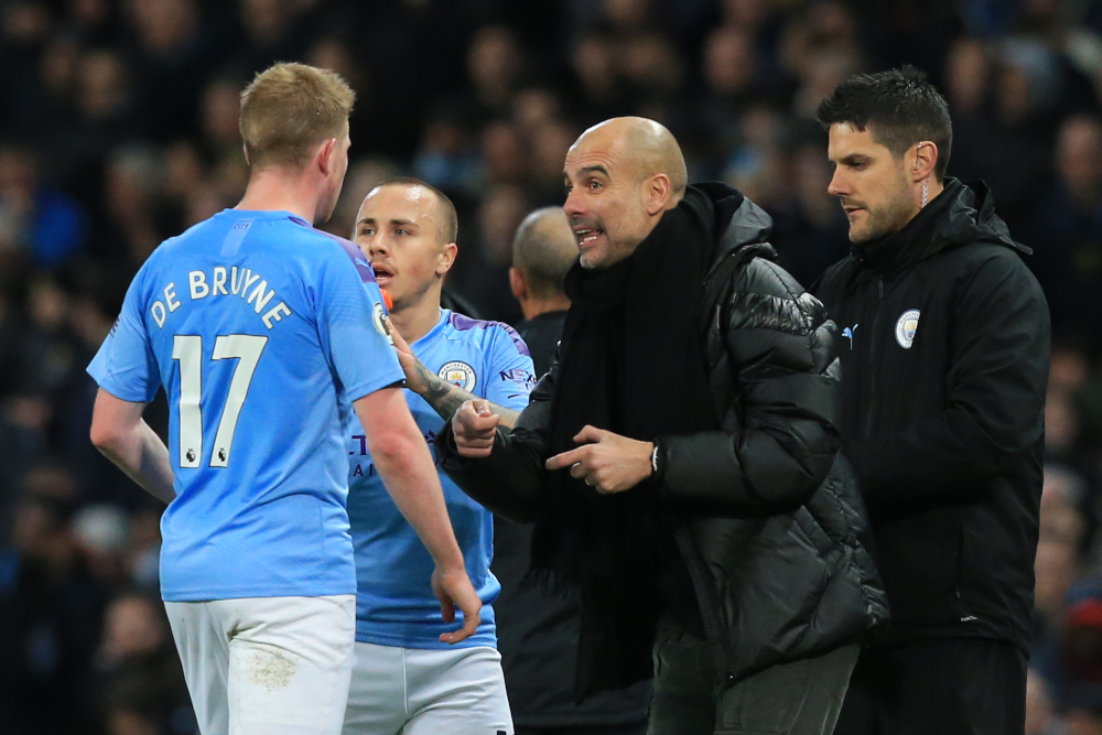 Manchester City manager Pep Guardiola talks with midfielder Kevin De Bruyne after their first goal during the English Premier League football match against Manchester United at the Etihad Stadium in Manchester December 7, 2019. u00e2u20acu201d AFP picnn