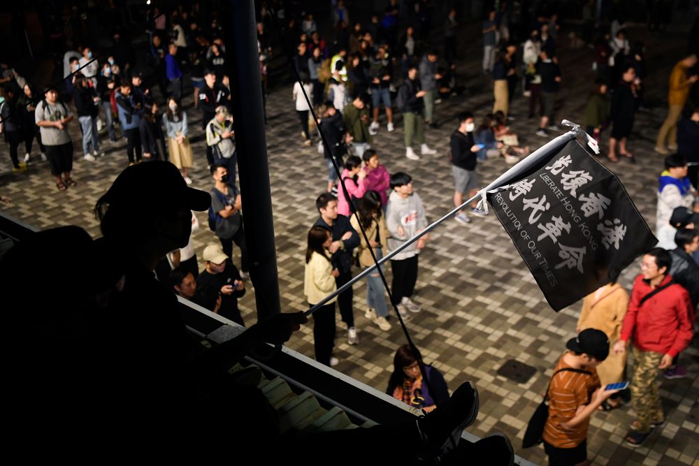 A man holds a flag reading u00e2u20acu02dcReclaim Hong Kong, Revolution of our Timeu00e2u20acu2122 as people celebrate the results of last weeku00e2u20acu2122s district council elections in the neighbourhood of Wong Tai Sin in Hong Kong, China November 30, 2019. u00e2u20acu201d Reuters pic