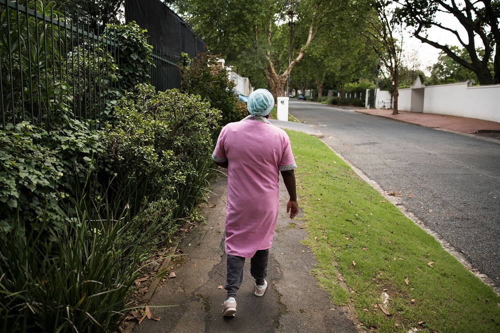 A domestic worker walks through the Parkwood Suburb of Johannesburg December 12, 2019. u00e2u20acu201d AFP pic 
