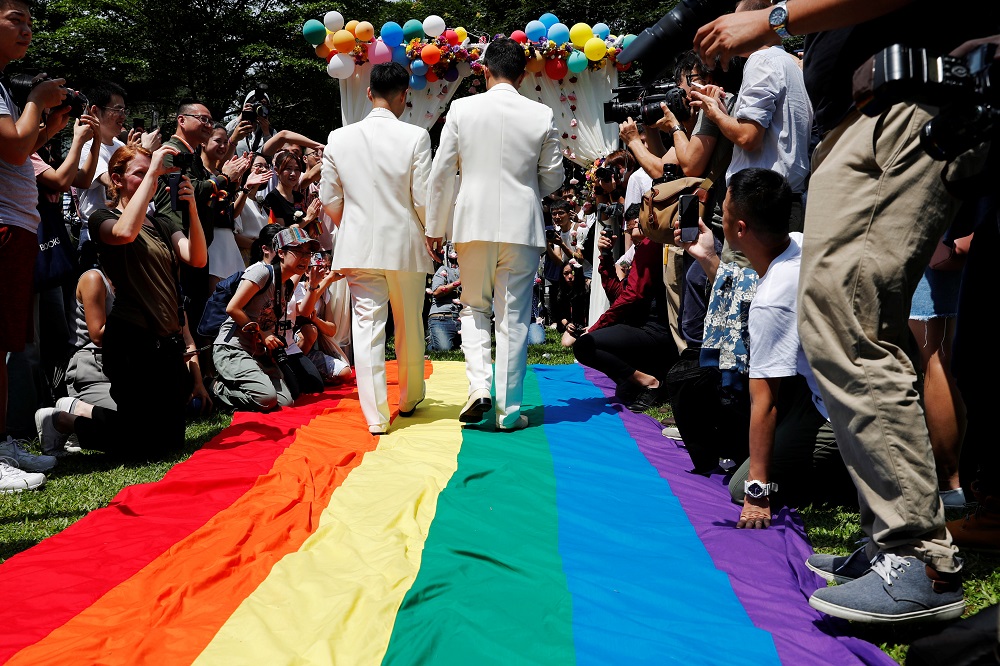 Gay newlyweds walk on a giant rainbow flag at a pro same-sex marriage party after registering their marriage in Taipei May 24, 2019. u00e2u20acu201d Reuters pic