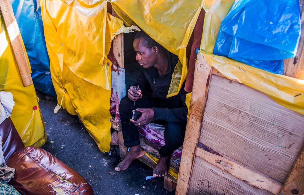 A sub-Saharan migrants sits through the entrance of a shack at the Oulad Ziane migrant camp in Casablanca March 27, 2019. u00e2u20acu201d AFP pic